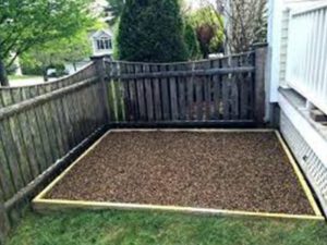 A backyard corner of a house designated as a popping yard for dogs