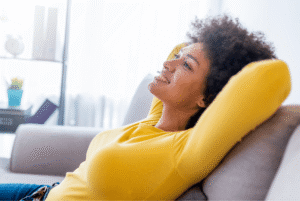 Woman smiling and relaxing on a sofa