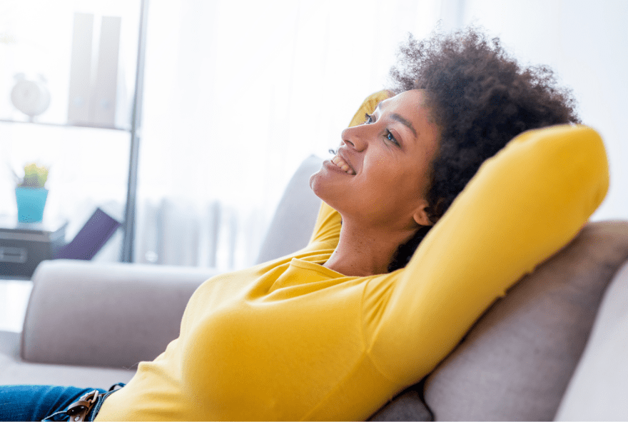 Woman smiling and relaxing on a sofa