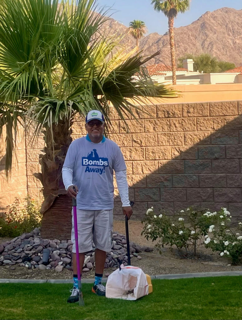 Bombs away team member cleaning yard
